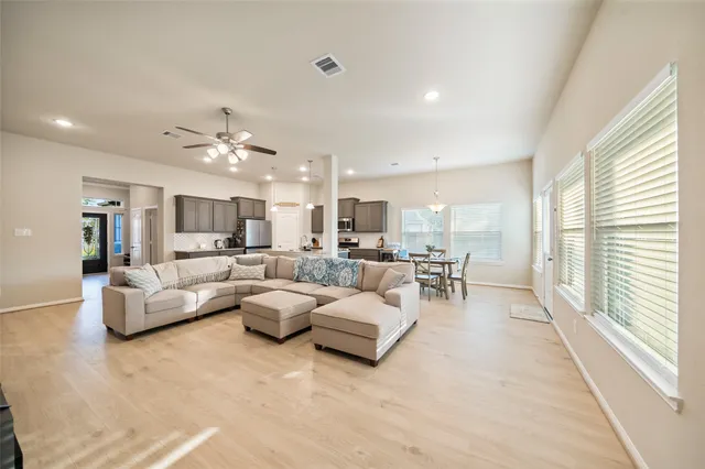 a living room with furniture and a large window