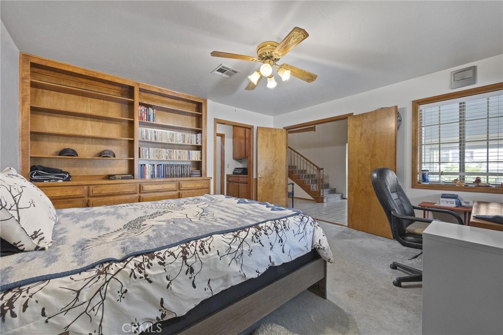 3512 McCray Road Mountain Mesa, CA 93240 - Photo 36 of 60 a bedroom with a large bed and wooden floor