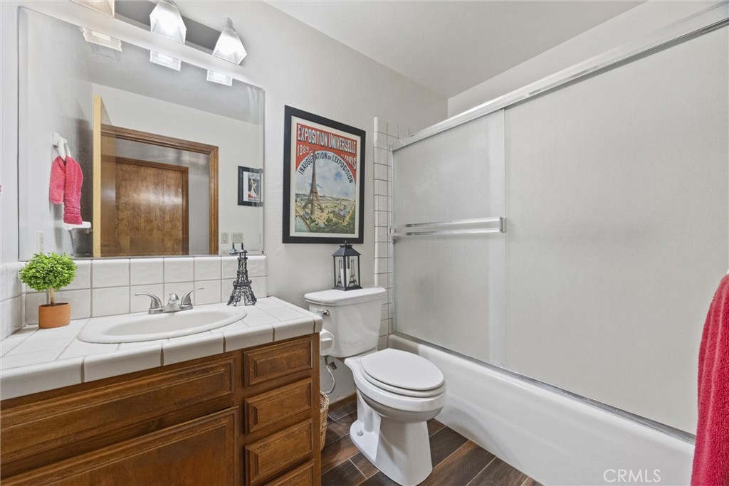 3512 McCray Road Mountain Mesa, CA 93240 - Photo 37 of 60 a bathroom with a toilet a sink and a mirror
