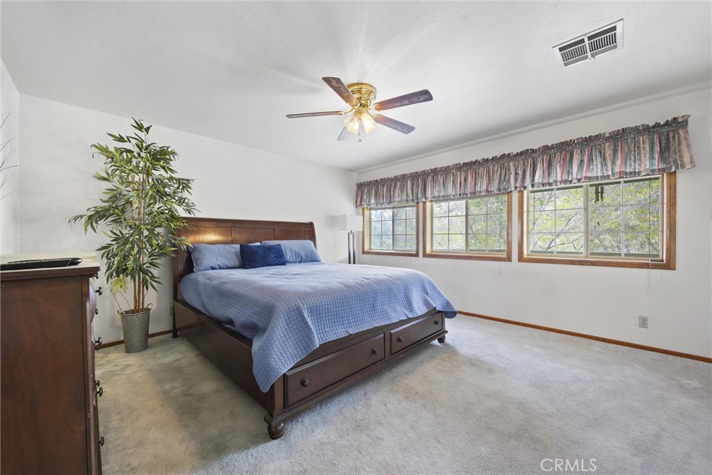 3512 McCray Road Mountain Mesa, CA 93240 - Photo 40 of 60 a spacious bedroom with a large bed and a potted plant