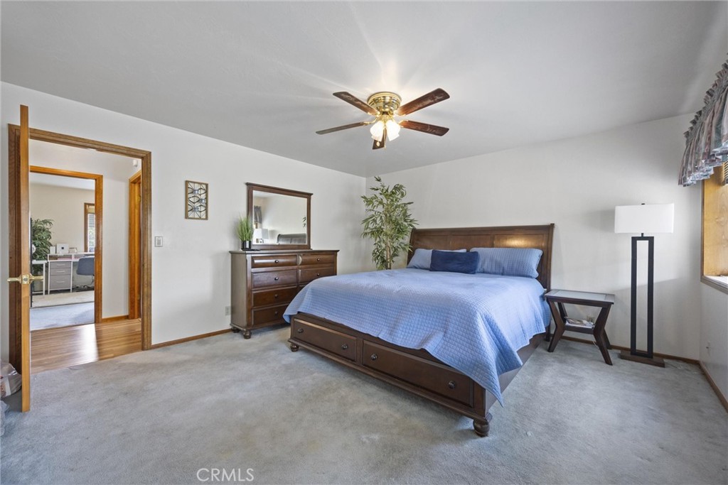3512 McCray Road Mountain Mesa, CA 93240 - Photo 41 of 60 a spacious bedroom with a bed and a chandelier