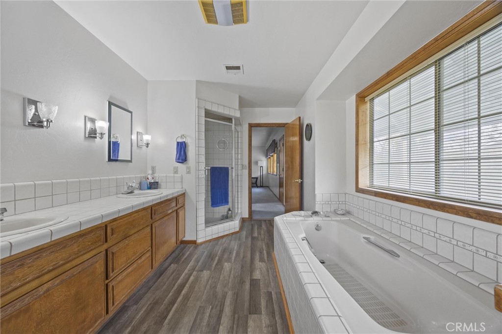 3512 McCray Road Mountain Mesa, CA 93240 - Photo 46 of 60 a large bathroom with a granite countertop tub a sink and a large window