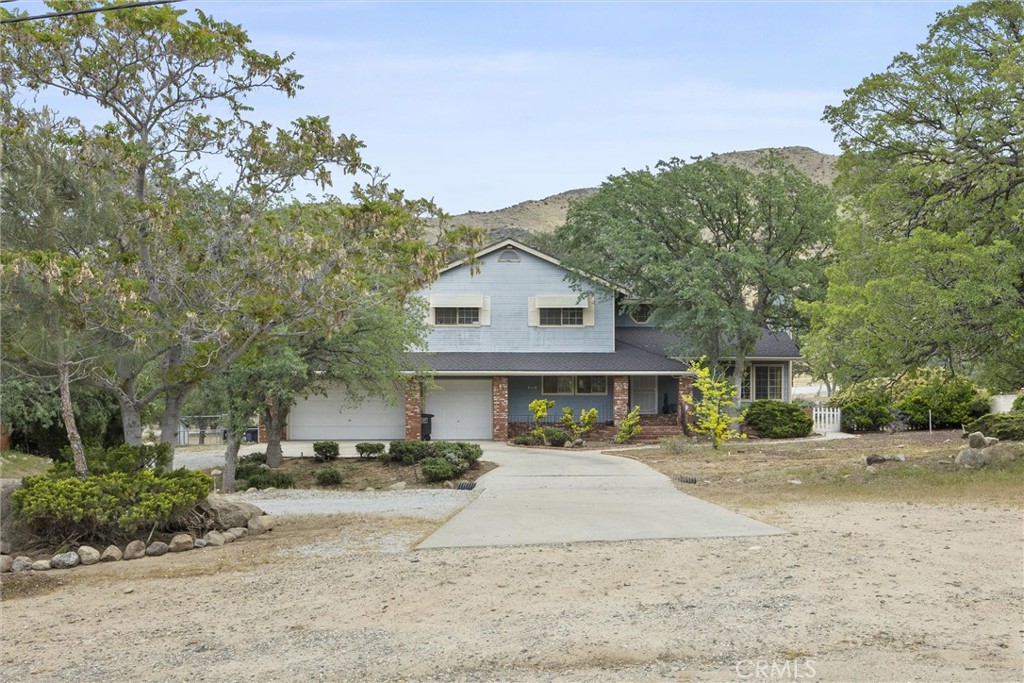 3512 McCray Road Mountain Mesa, CA 93240 - Photo 9 of 60 a front view of a house with a yard and potted plants