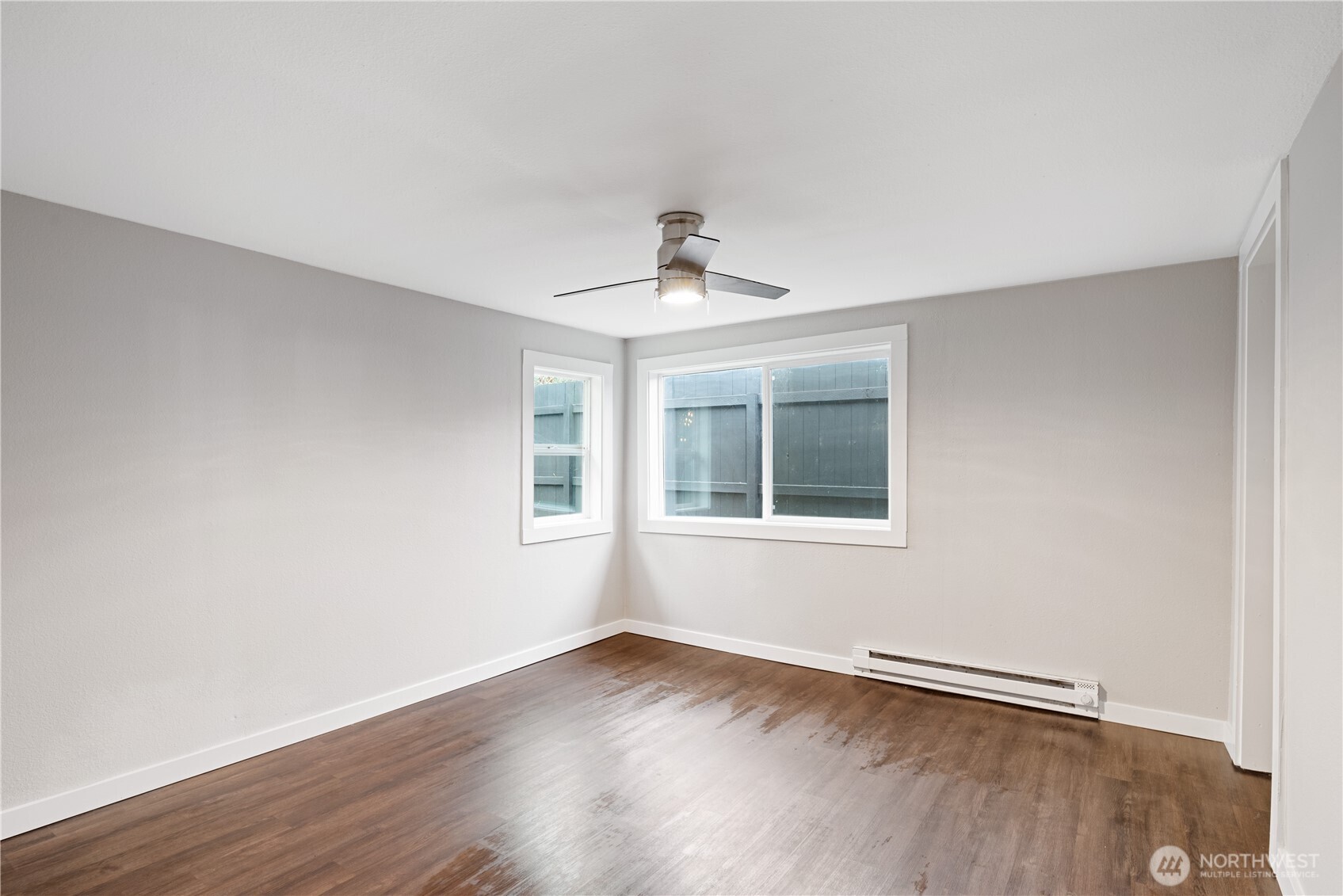 3317 Olive Way Longview, WA 98632 - Photo 12 of 29 a view of an empty room with wooden floor and a window