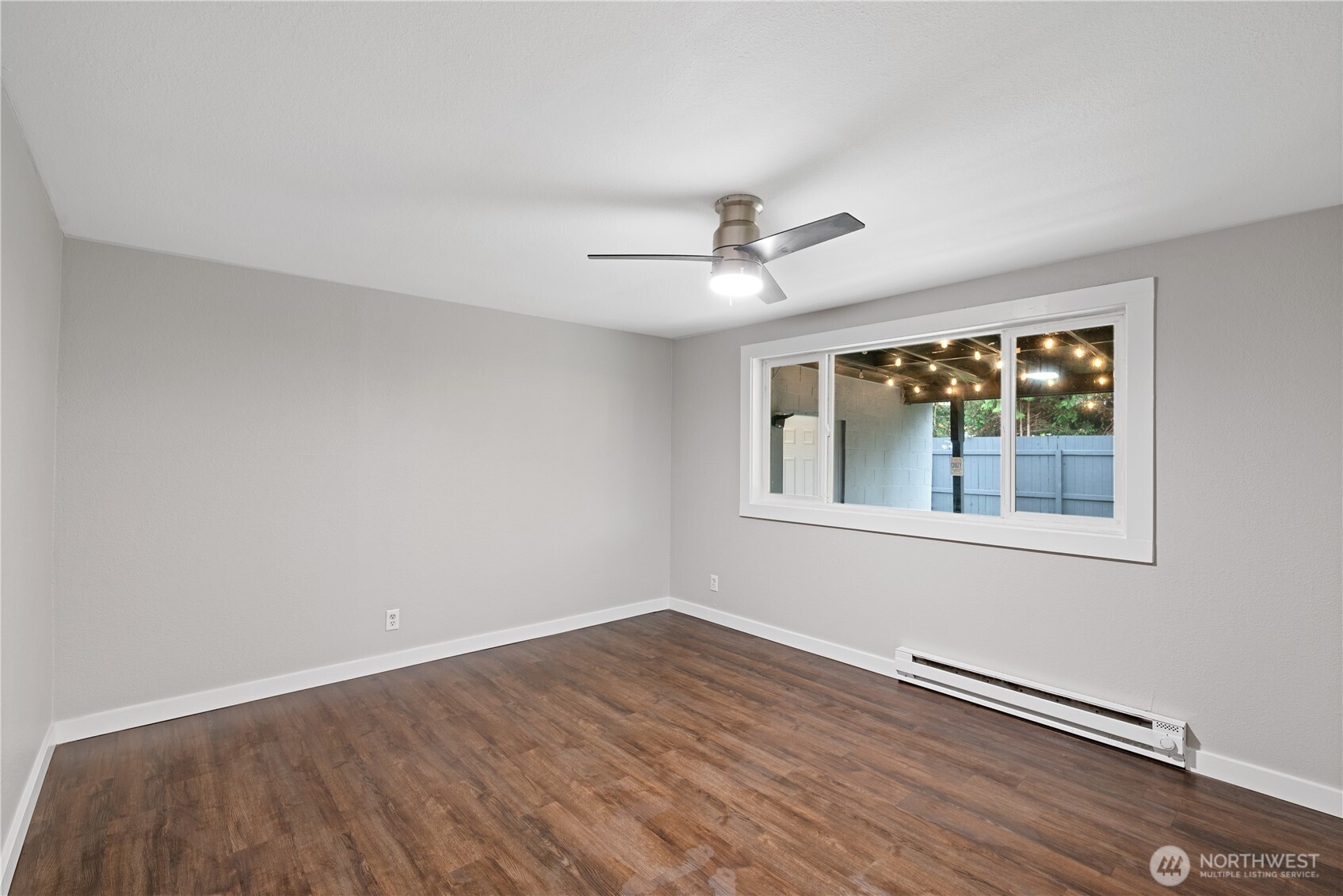 3317 Olive Way Longview, WA 98632 - Photo 15 of 29 a view of an empty room with wooden floor and a window