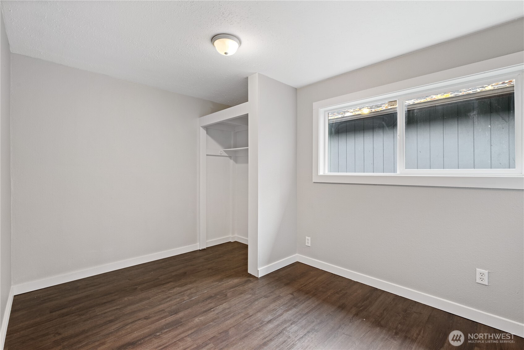 3317 Olive Way Longview, WA 98632 - Photo 18 of 29 a view of an empty room with wooden floor and a window
