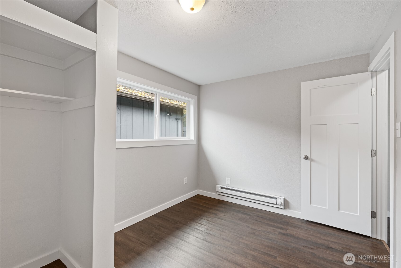 3317 Olive Way Longview, WA 98632 - Photo 19 of 29 a view of an empty room with wooden floor and a window