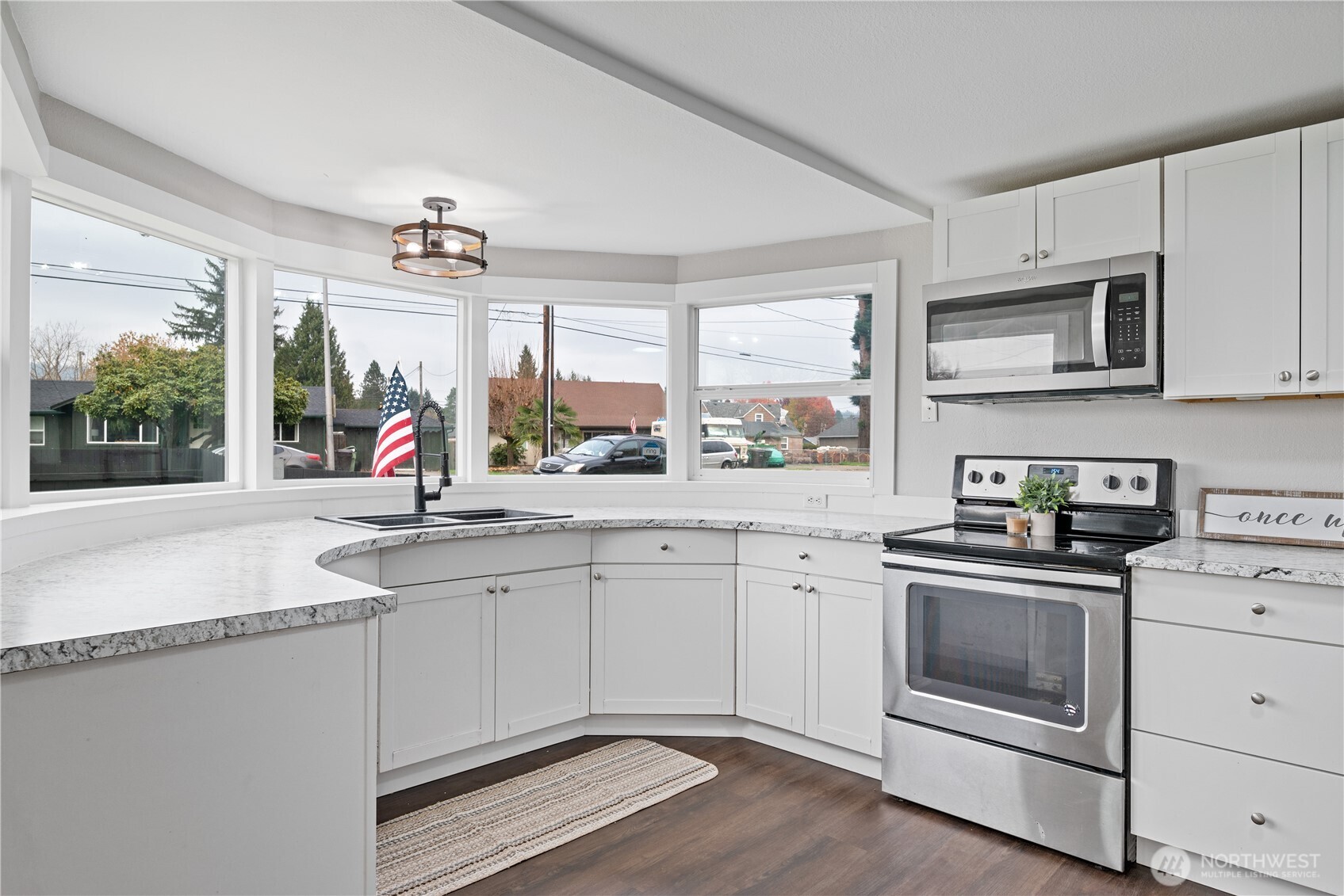 3317 Olive Way Longview, WA 98632 - Photo 8 of 29 a kitchen with granite countertop a sink stainless steel appliances and cabinets
