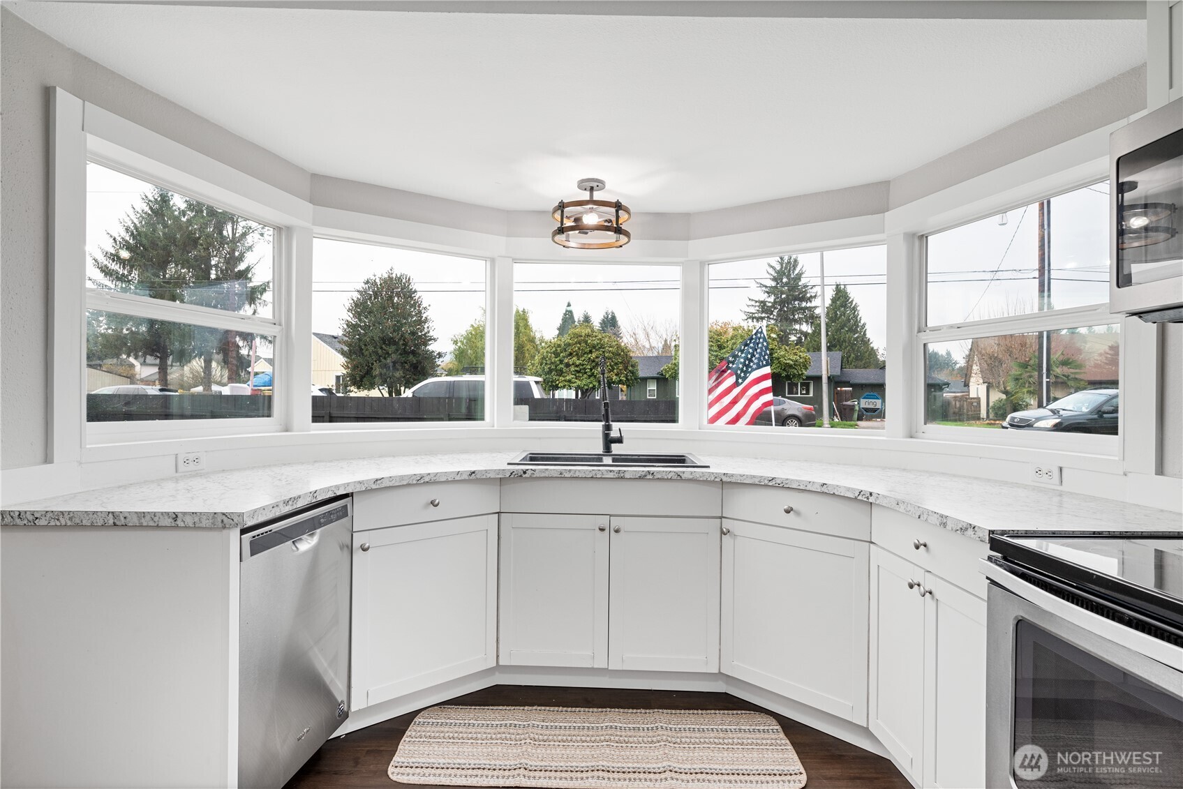 3317 Olive Way Longview, WA 98632 - Photo 9 of 29 a kitchen with stainless steel appliances granite countertop white cabinets and a large window