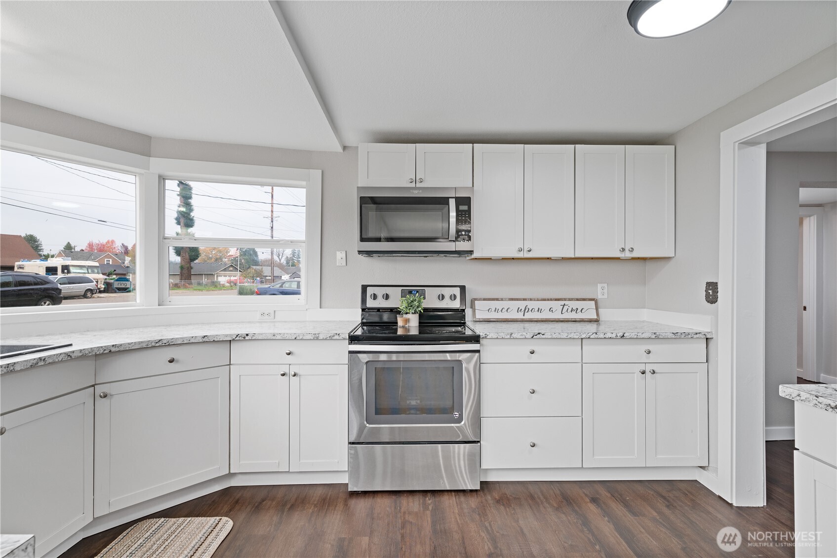 3317 Olive Way Longview, WA 98632 - Photo 10 of 29 a kitchen with white cabinets stainless steel appliances and sink