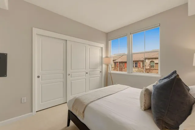 a bedroom with a bed and cabinet