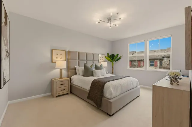 a spacious bedroom with a bed and a chandelier