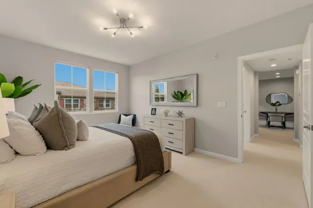 a bedroom with a bed and a large mirror