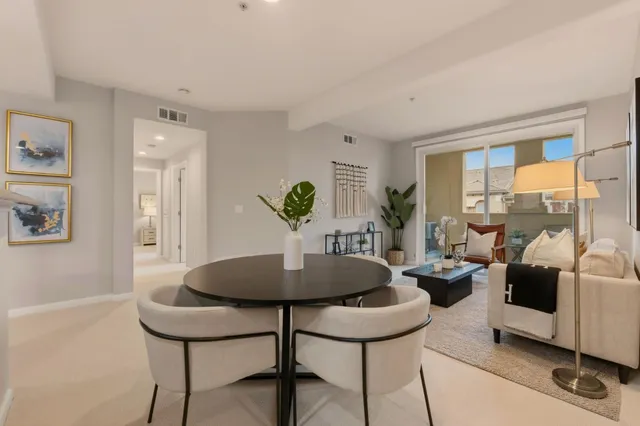 a living room with furniture and a potted plant
