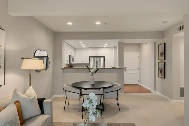 a living room with furniture a mirror and a lamp