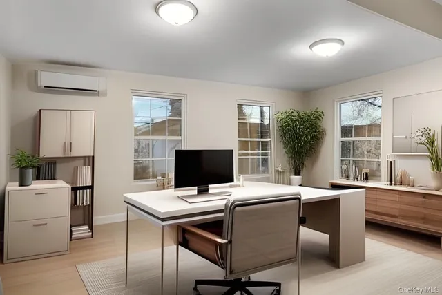 a view of a workspace with furniture and a window