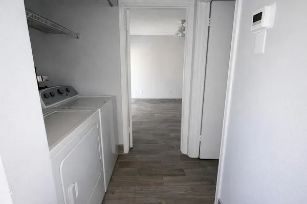a utility room with cabinets washer and dryer