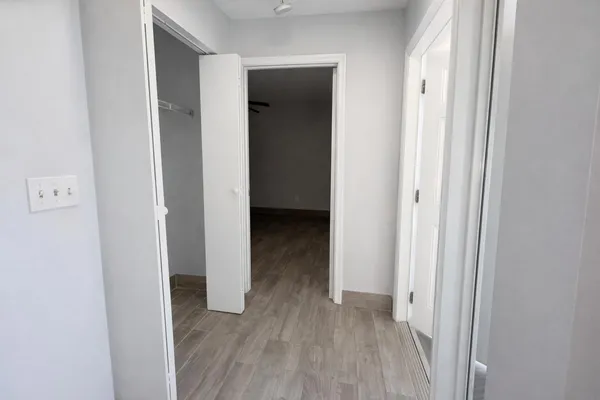 a view of a hallway with wooden floor