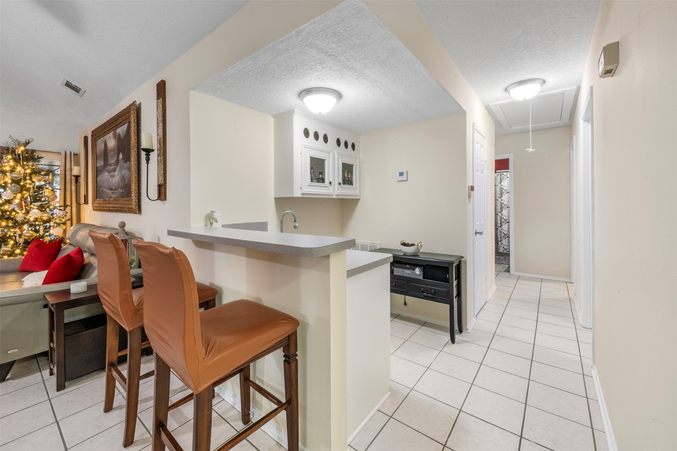 1114 Poppets Way Crosby, TX 77532 - Photo 16 of 48 Custom wet bar with shelving and bar seating perfect for entertaining and enjoying quiet evenings at home.