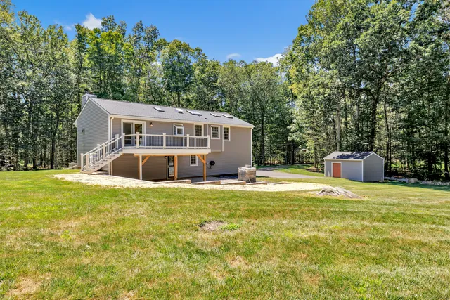 a view of a house with pool and sitting area