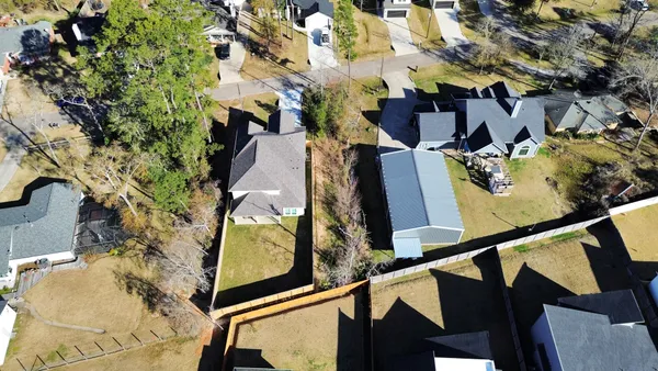 an aerial view of residential houses with outdoor space