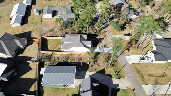 an aerial view of residential houses with outdoor space