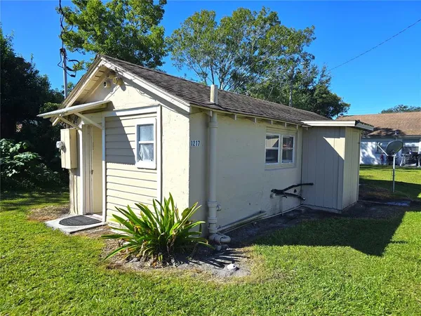 a view of a house with a yard and plants
