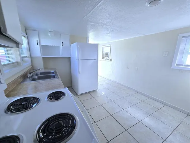 a kitchen with a stove and a refrigerator