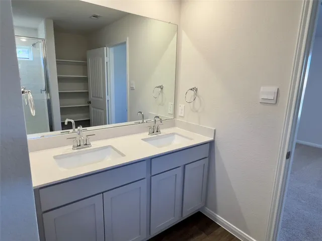 a view of an empty room with closet and a window