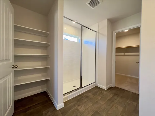 a bathroom with a glass shower door