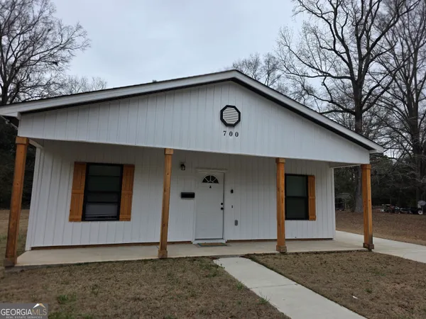 a house with trees in the background
