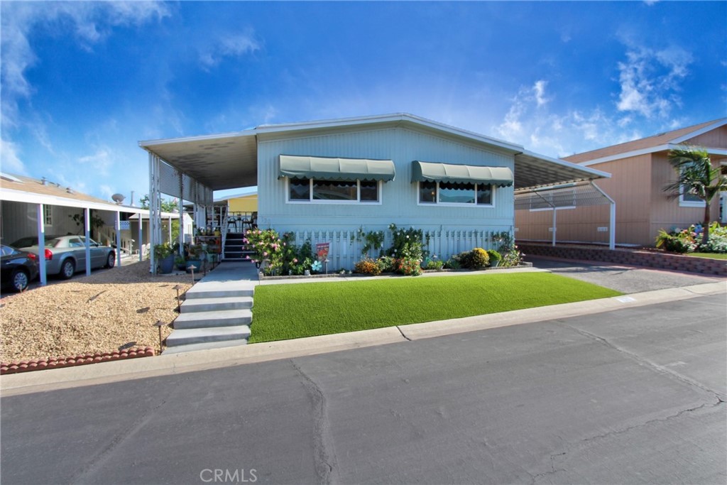 4000 Pierce Street, Unit 130 Riverside, CA 92505 - Photo 1 of 1 a front view of a house with a yard and garage