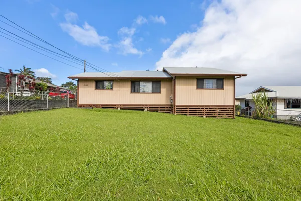 a front view of house with yard and outdoor seating