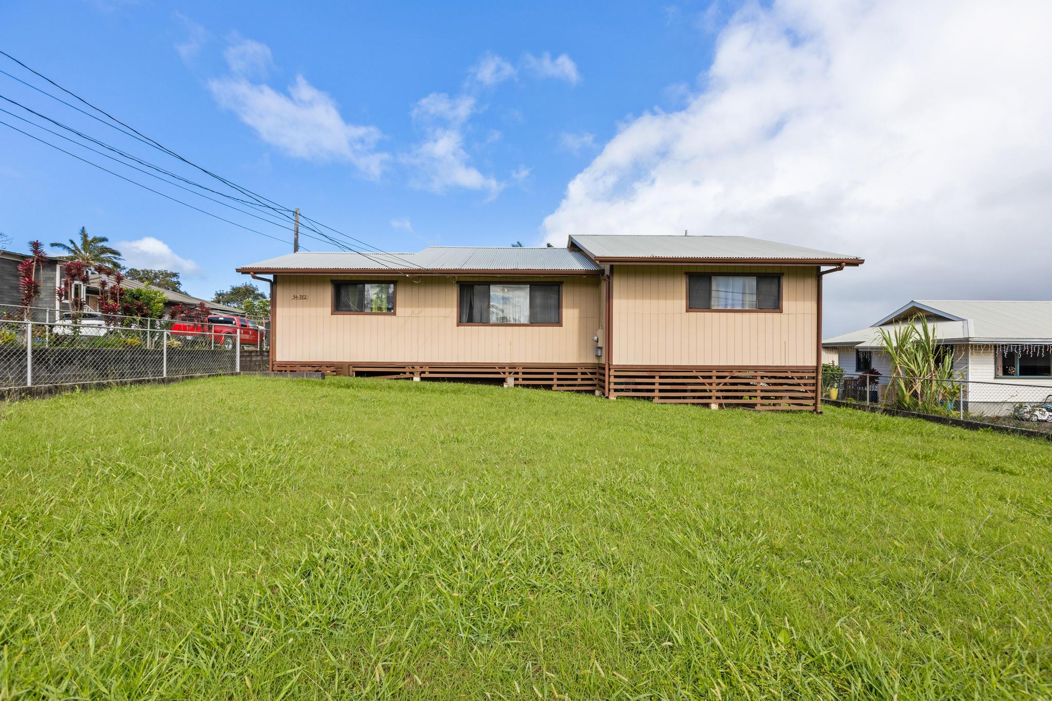 a front view of house with yard and outdoor seating