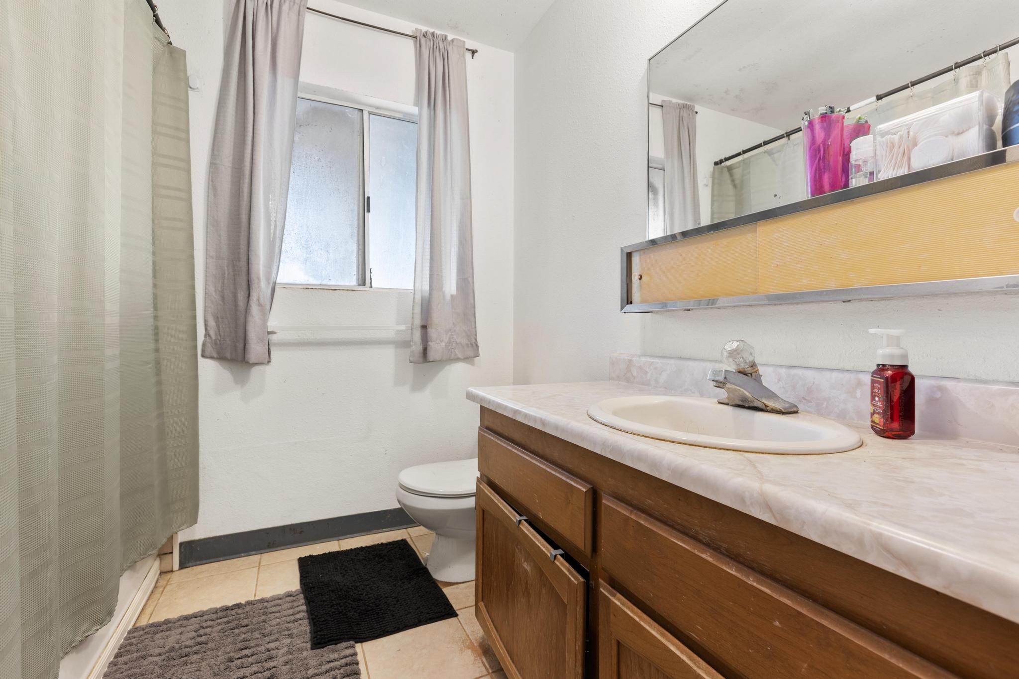 54-382 Union Mill Road Kapaau, HI 96755 - Photo 22 of 28 a bathroom with a granite countertop sink and a mirror