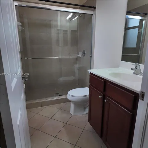 a bathroom with a shower a toilet and a sink
