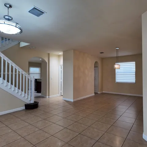 a view of a hallway with workspace and a bathroom