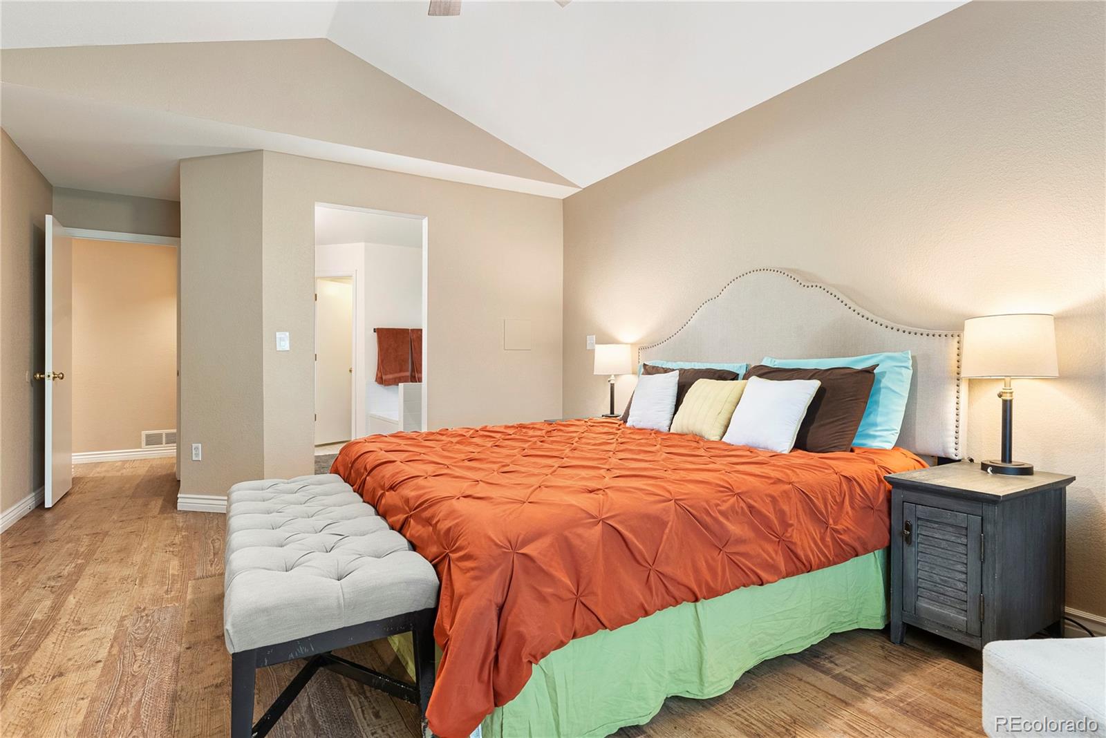 9756 Quay Loop Broomfield, CO 80021 - Photo 18 of 32 a bedroom with a bed and a lamp