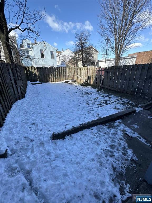 108 Madison Street Paterson, NJ 07501 - Photo 11 of 15 a view of a yard with wooden fence