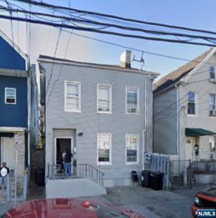 108 Madison Street Paterson, NJ 07501 - Photo 12 of 15 a front view of a house with outdoor seating