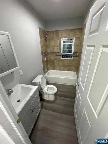 a bathroom with a bathtub sink and toilet
