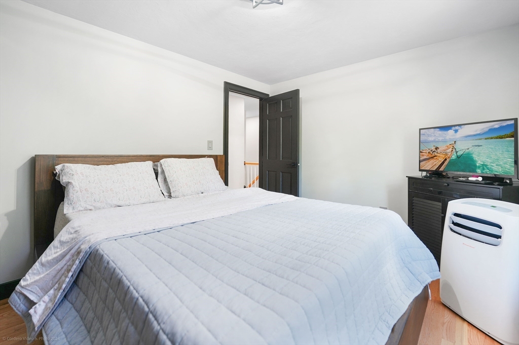 13 Gerrish Road Rochester, MA 02770 - Photo 23 of 30 a bedroom with a bed and a flat screen tv