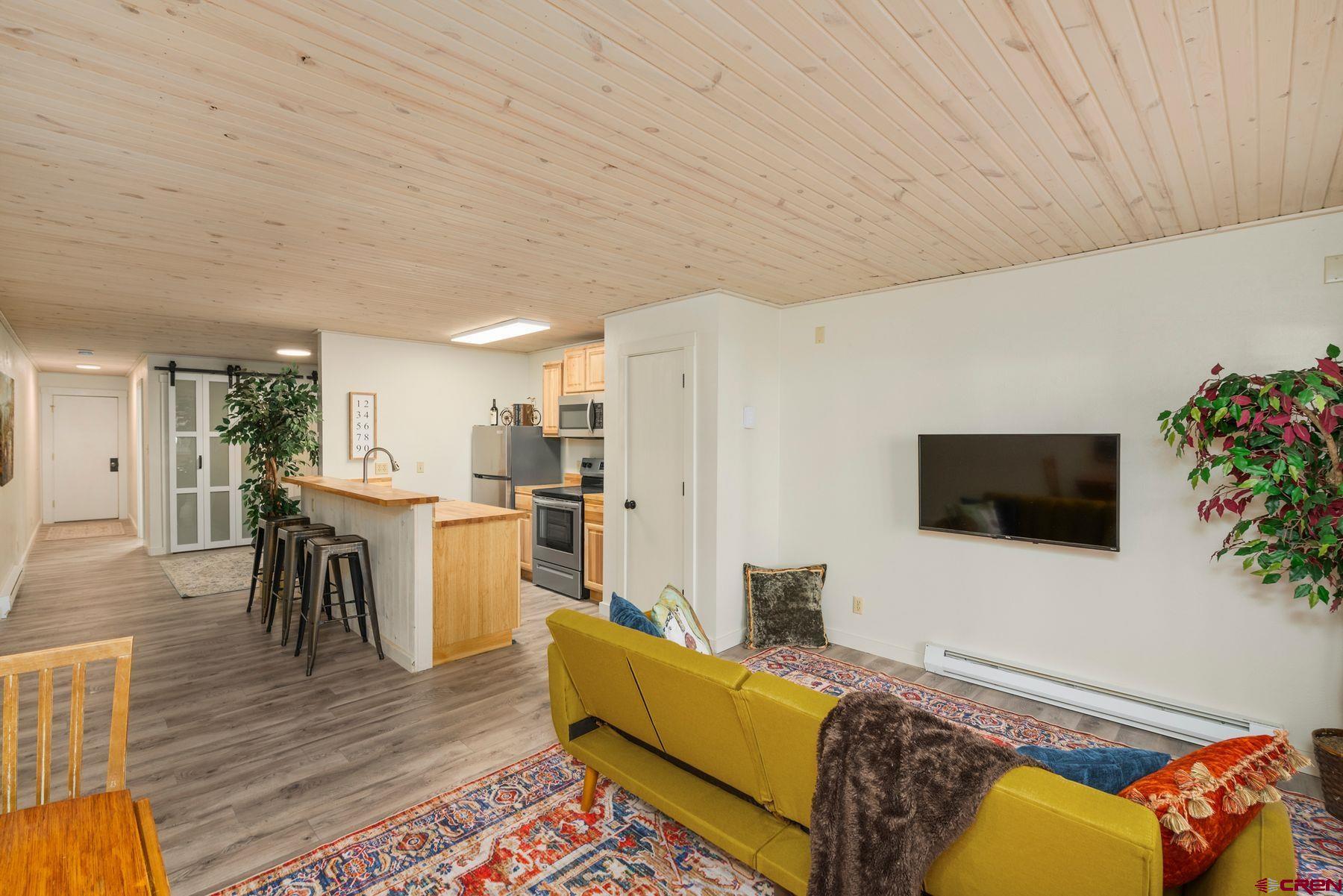 35 Emmons Road, Unit A Crested Butte, CO 81225 - Photo 10 of 28 a living room with furniture and a flat screen tv