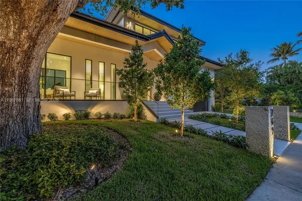 a kitchen with stainless steel appliances a white table chairs and a refrigerator