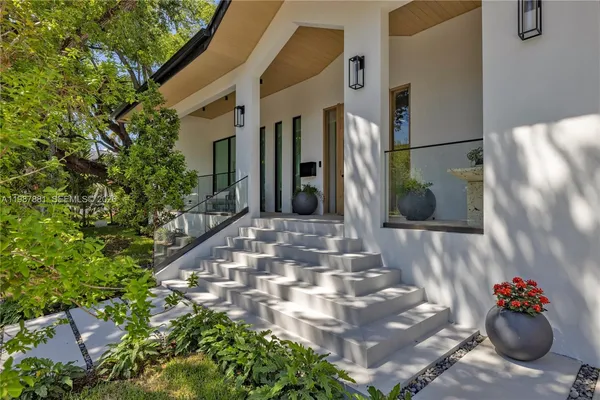 a kitchen with stainless steel appliances kitchen island granite countertop a refrigerator a sink and a stove
