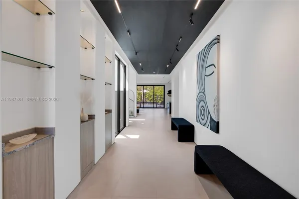a view of a dining room with furniture large windows and wooden floor