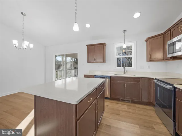 a kitchen with counter top space a sink and appliances