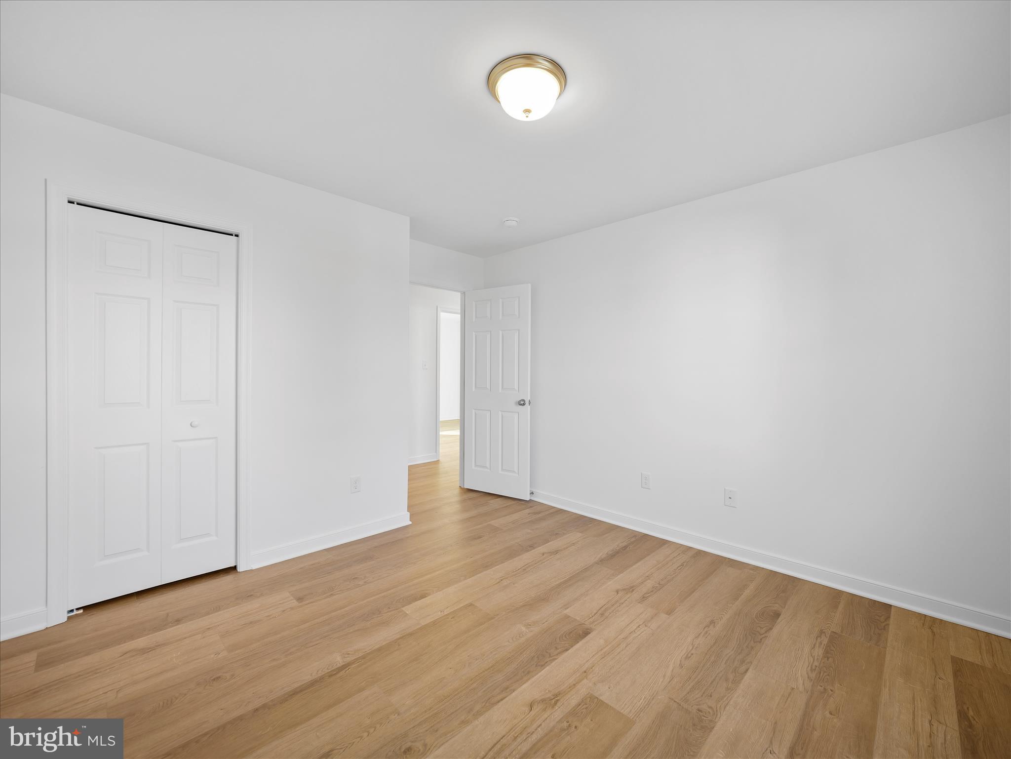 110 Hykes Road East Greencastle, PA 17225 - Photo 22 of 40 a view of an empty room with wooden floor and a window