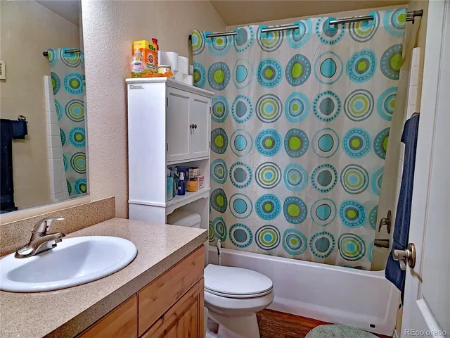 a bathroom with a sink toilet and a mirror
