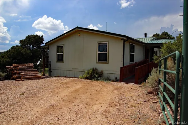 a view of a house with wooden fence